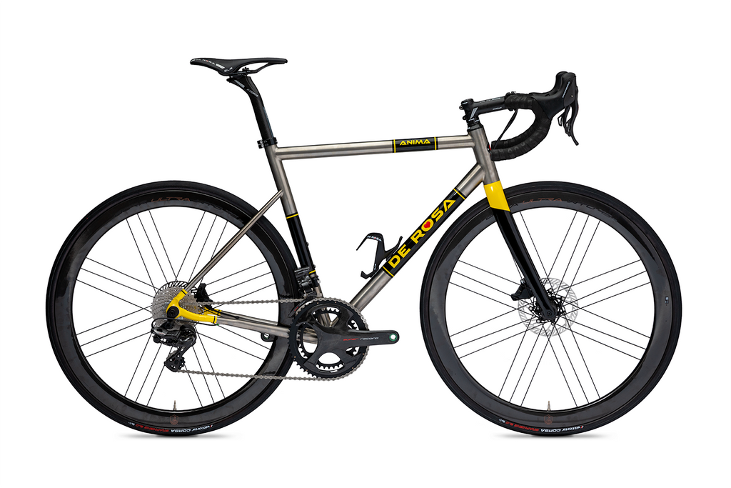 Titanium road bike in silver with black and yellow accents