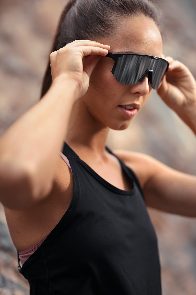 Girl in sports gear wearing BLIZ Hero Sunglasses with black frame