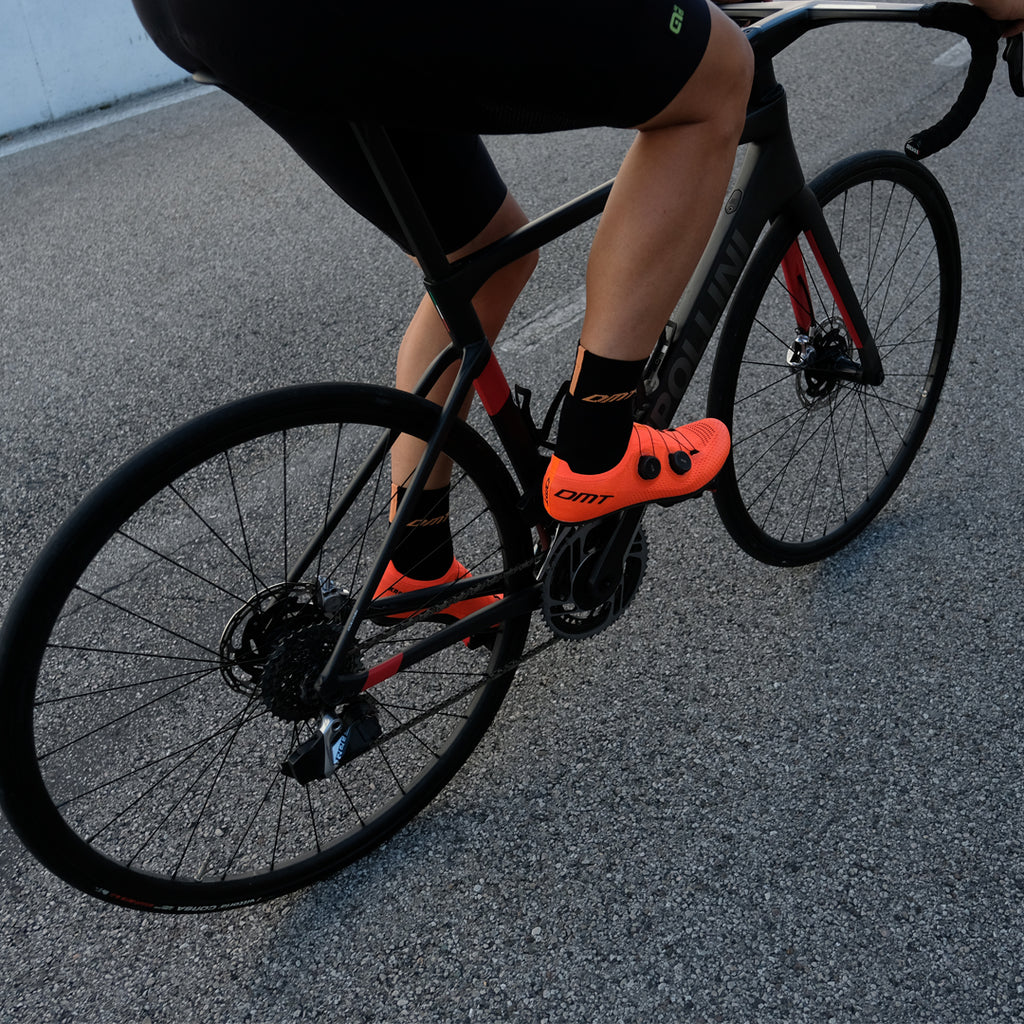 Man riding bike wearing DMT KR0 Orange Road Bike 3D Knit Cycling Shoe